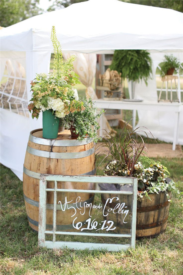 Outdoor rustic wedding decor ideas with wildflowers and wine barrels