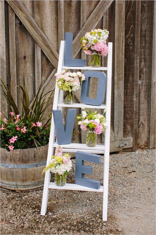 Place letters on a ladder with flower arrangements