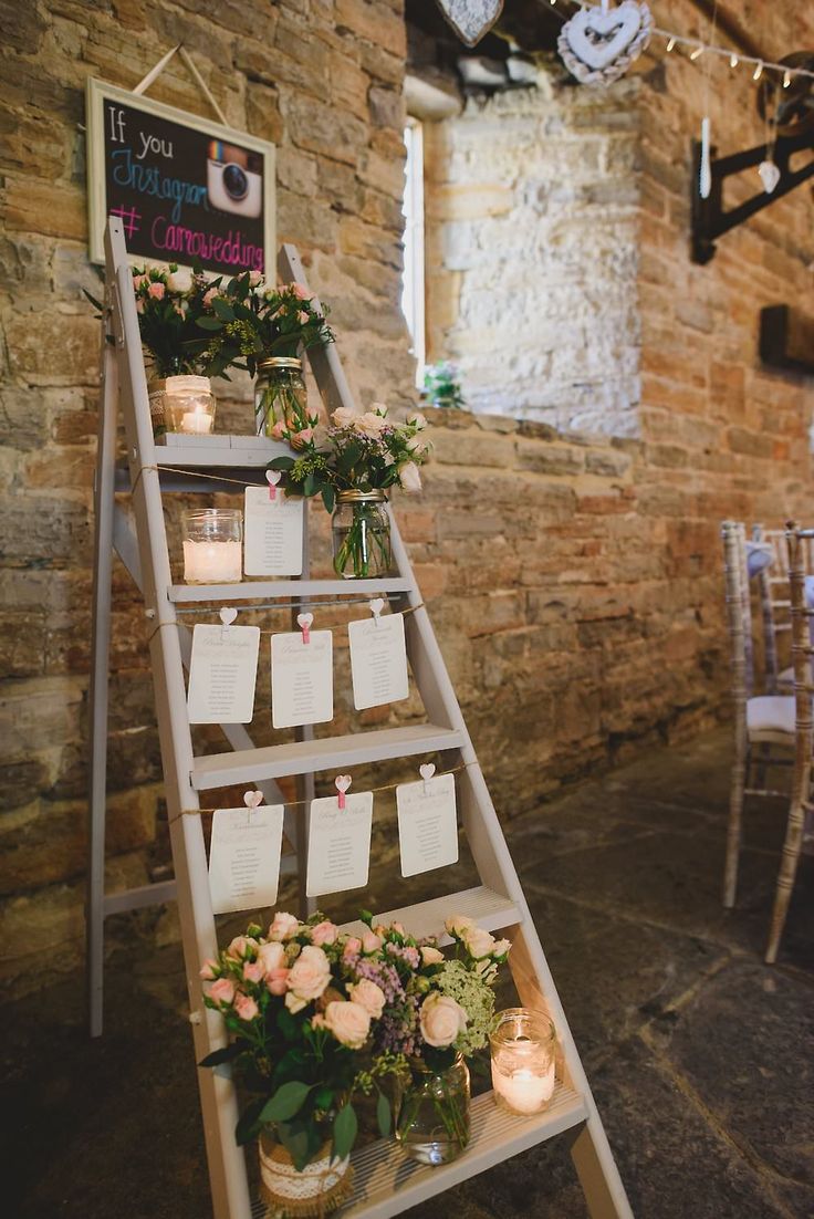 Step ladder table plan with candles, glass jars filled with flowers and strung up stationery
