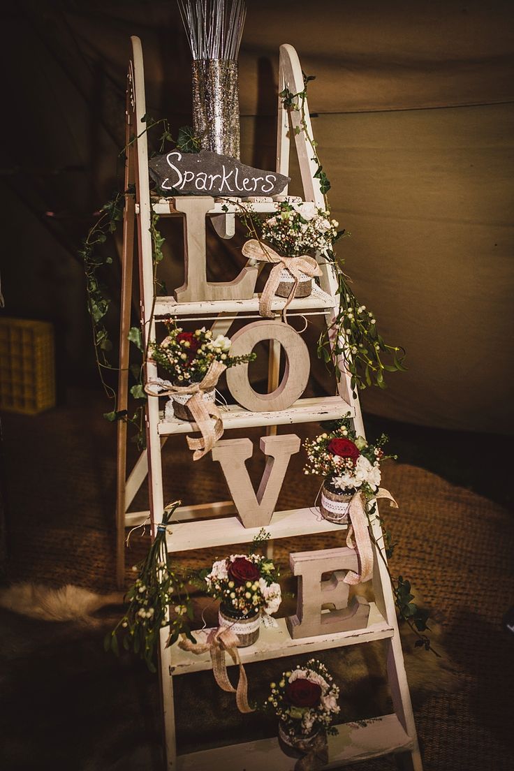 Vintage step ladder display with wooden LOVE letters sparkler bucket & jars filled with flowers