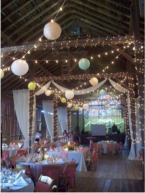 globe lights lanterns christmas lights and drapery for barn wedding