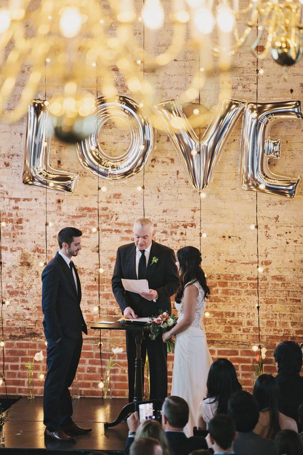 industrial ceremony with LOVE backdrop