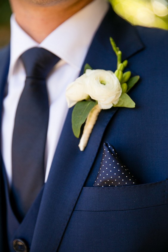 navy blue groom attire and white boutonniere