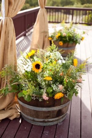 rustic wine barrel wedding ceremony tubs of field flowers