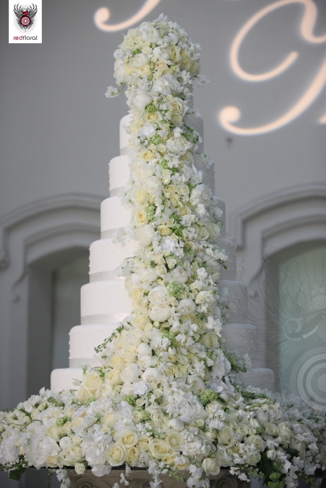 white big wedding cake with white and yellow flowers