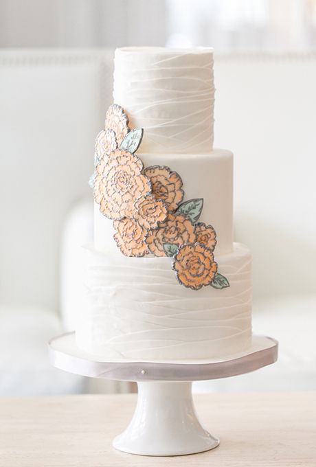 white wedding cake with pastel yellow flower