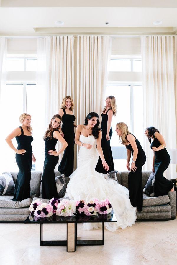 Bridesmaids in elegant black full length dresses