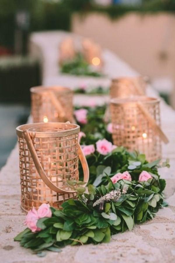 Gold candle holders and garland wedding table decor