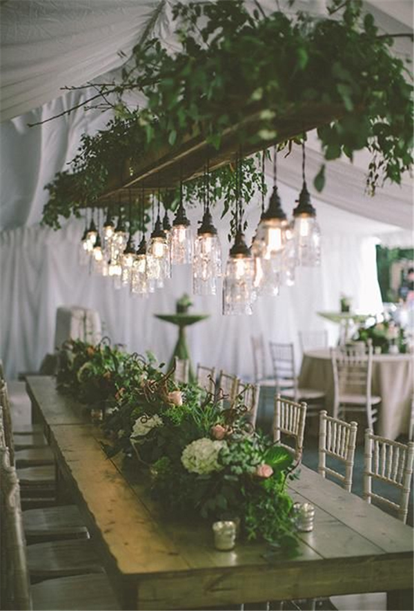 Low-hanging edison bulbs strung from a floral chandelier