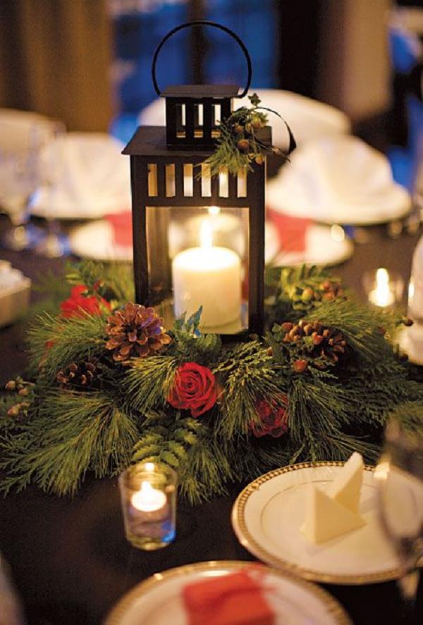 Winter Wedding Flowers. Wedding centerpiece of lanterns, pine boughs, roses, and pinecones
