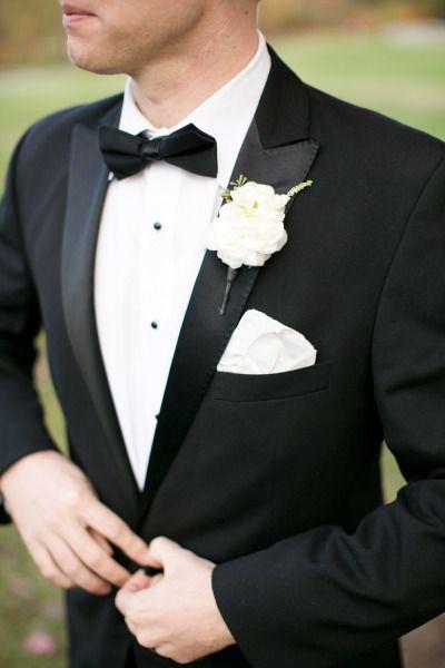 black groom attire and white flower