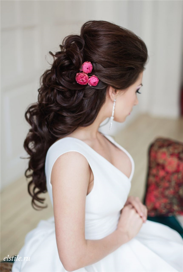 black half down half up bridal hairstyle with pink flowers