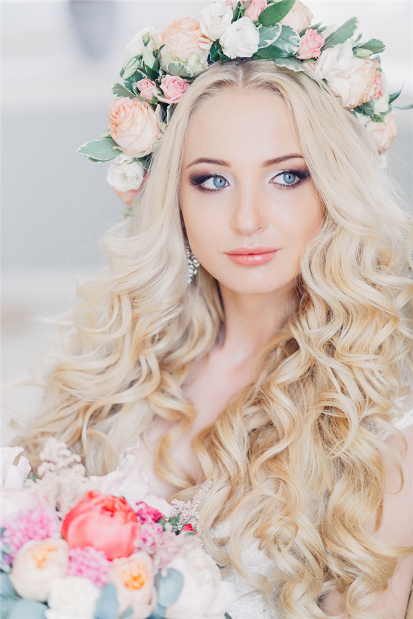 bloned long wavy wedding hairstyle with pastel flower crown