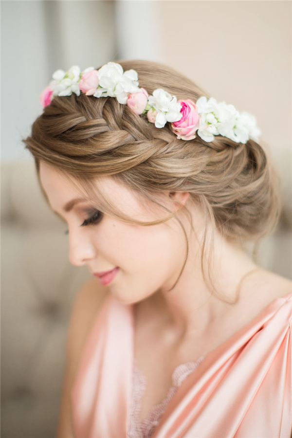 braided wedding hairstyle witn pastel flower crown