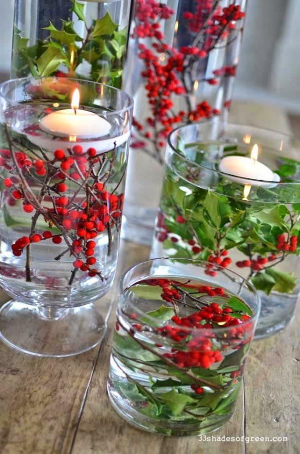 clear glass vases, berries and greenery and floating candles Christmas Centerpiece