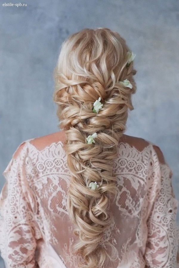 long curly braided hairstyle with flowers