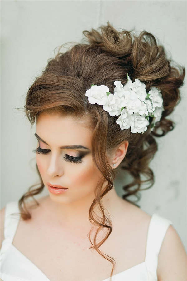25 Romantic Long Wedding Hairstyles Using Flowers 21 loose wavy wedding updo with white flower headpiece