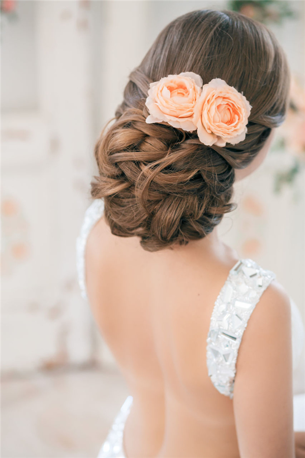 25 Romantic Long Wedding Hairstyles Using Flowers 22 messy low updo hairstyle with coral roses