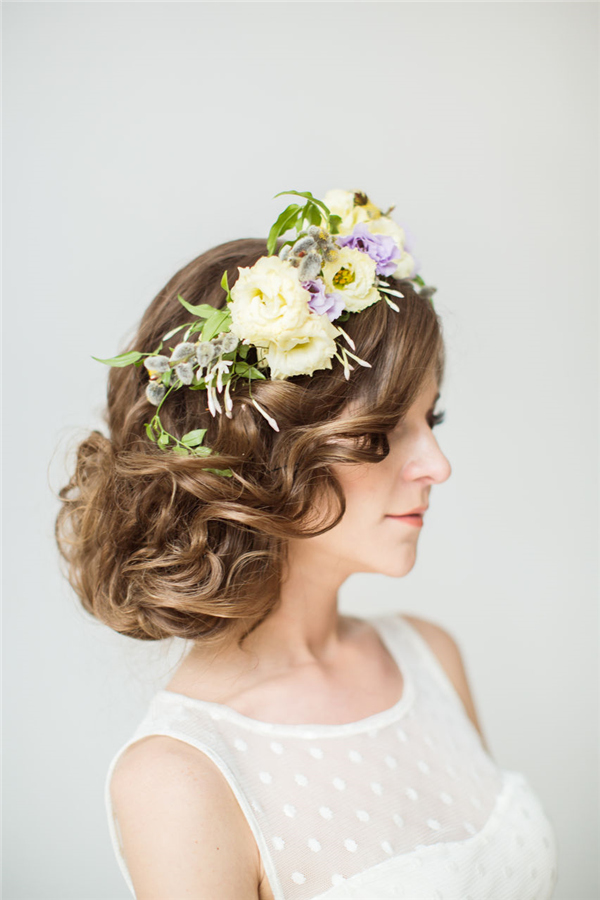 messy low updo hairstyle with yellow flowers crown
