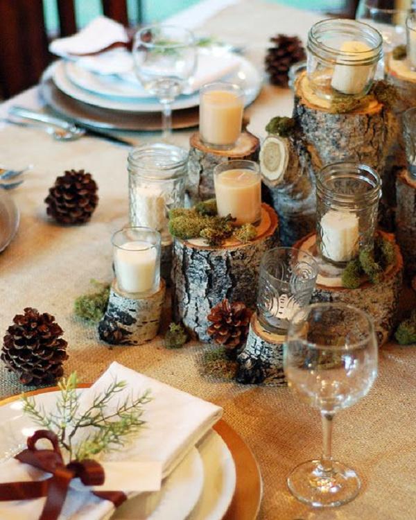 tree stump pinecones moss and candles winter wedding table setting