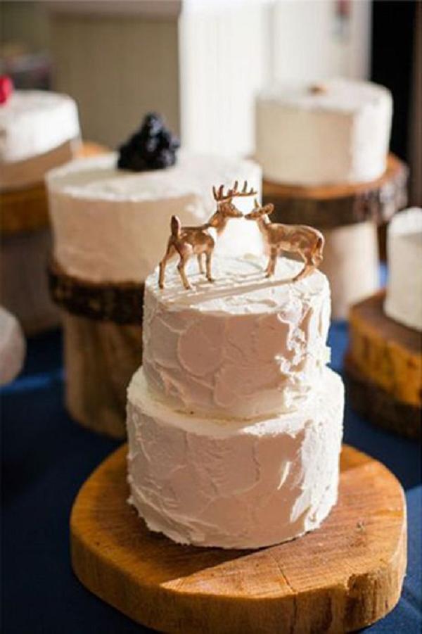 two-tier winter wedding cake with deer cake toppers