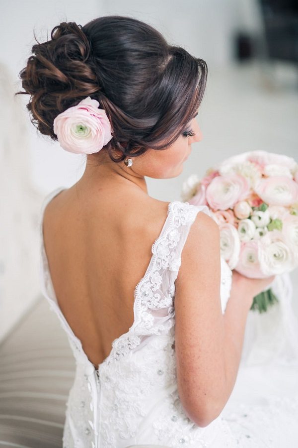 wedding updo hairstyle with pink flower