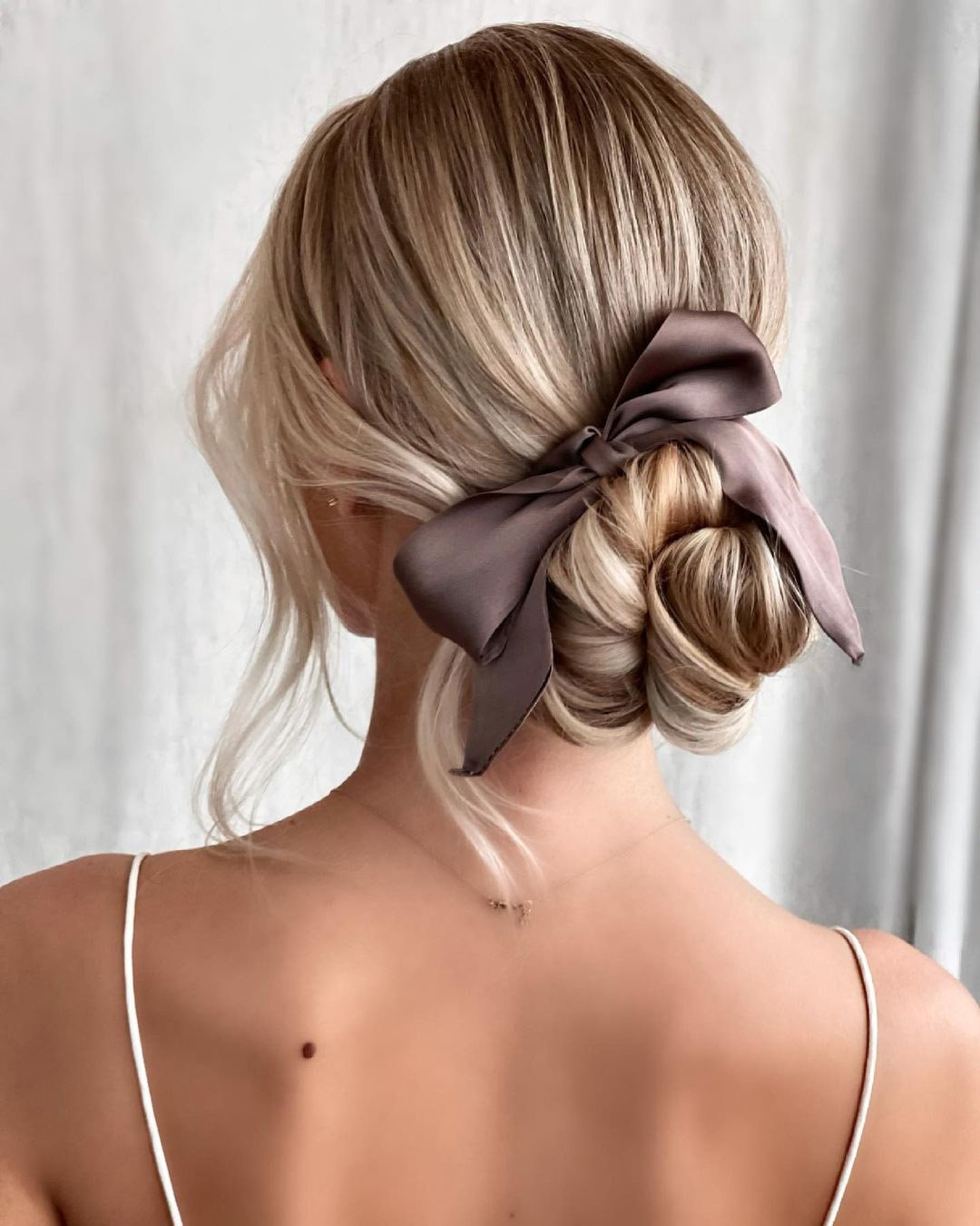 updos smooth elegant low bun with silk bow kasia fortuna