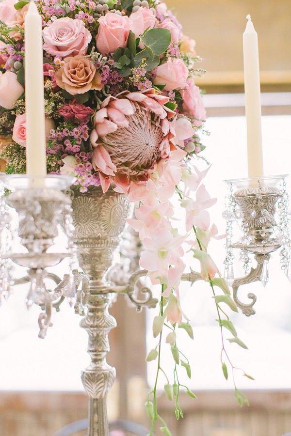 Cascading wedding centerpiece with protea, roses and orchids