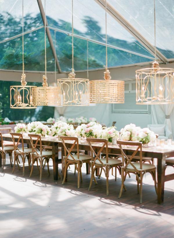 Long tables paired with gilded lighting fixtures wedding decor