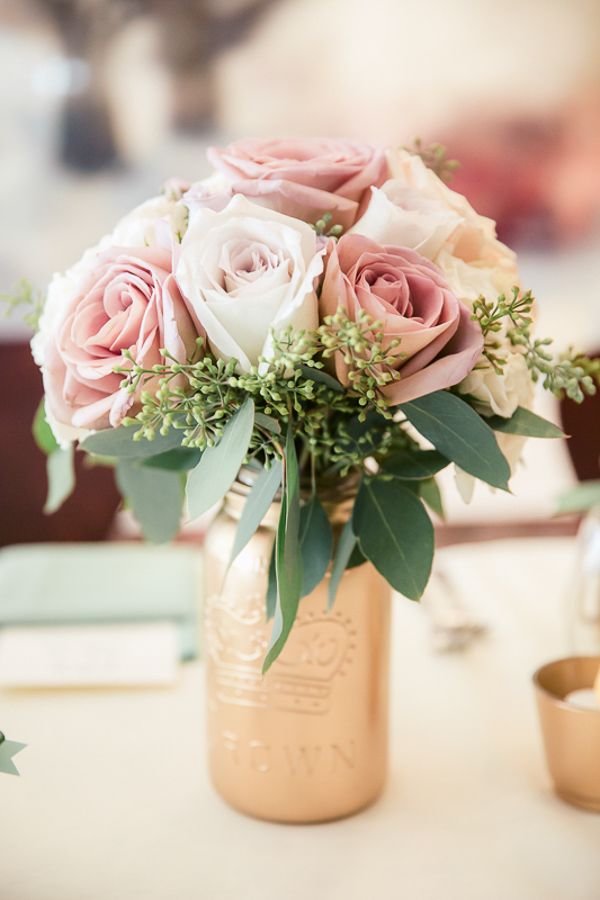 Wedding centerpiece idea spray paint gold bottles and fill with florals