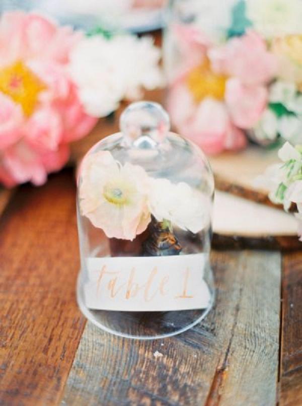 glass dome and pink flowers wedding centerpiece