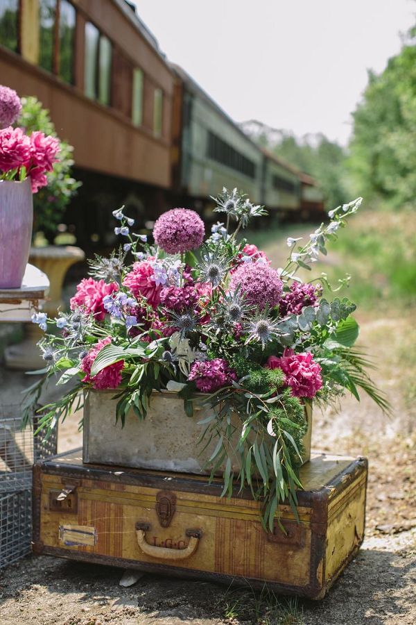 old suit cases purple wedding flowers