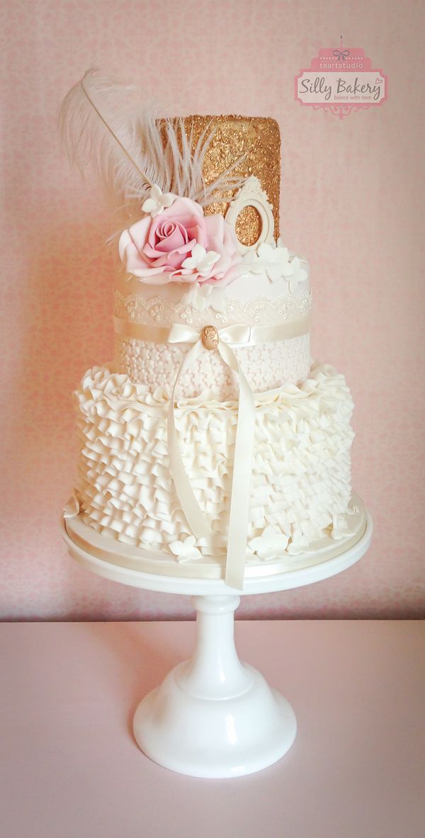 vintage white and glitter ruffled wedding cake with feather