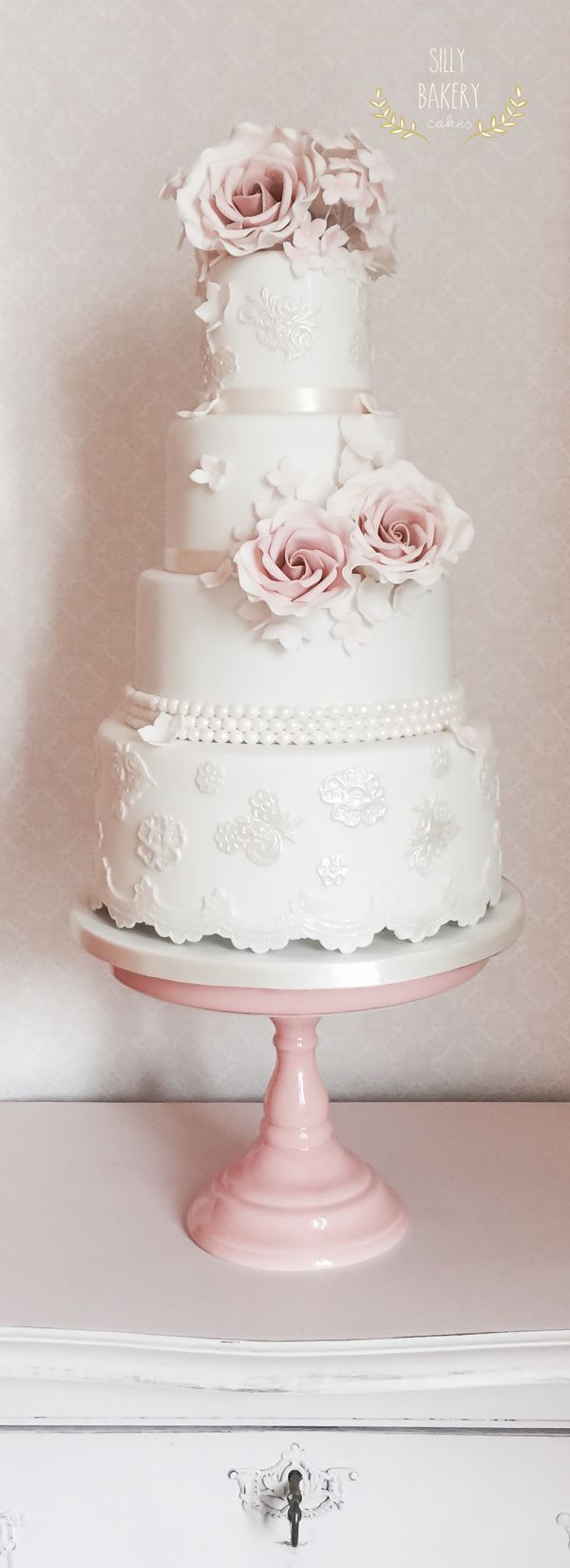 white wedding cake with sugar lace and roses