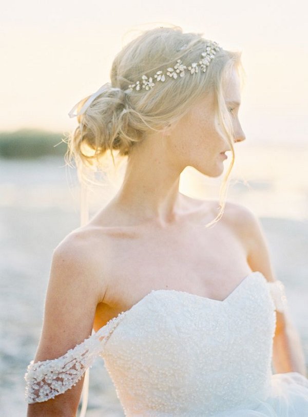 Loose bridal bun hairstyle and off the shoulder beaded wedding dress