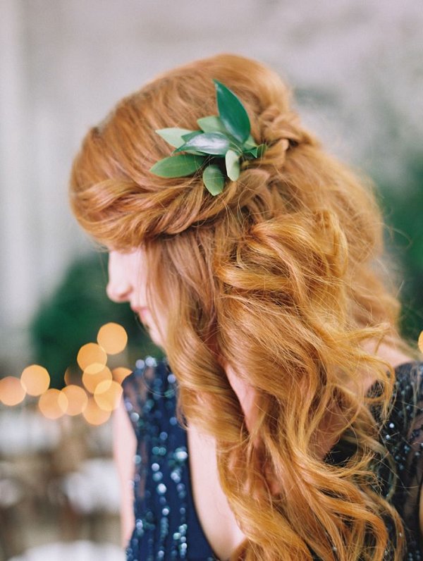 gold half up half down wavy hairstyle with green leaf