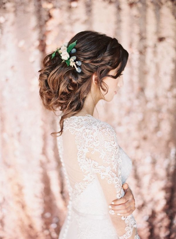messy low wedding updo chignon hairstyle with rustic flowers