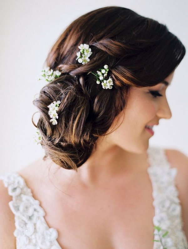 rustic low wedding updo hairstyle with white wildflowers