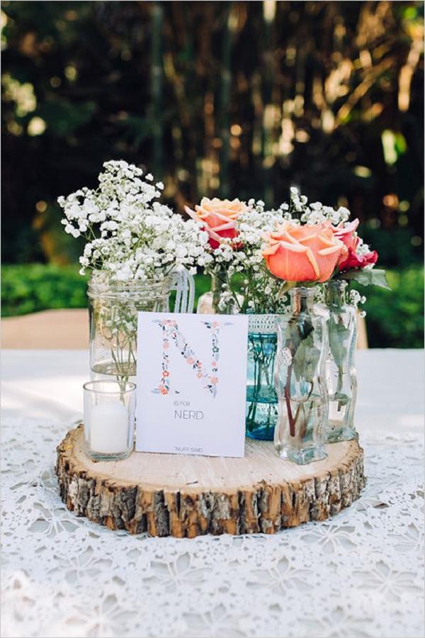rustic roses and baby’s breath with tree stump wedding centerpiece