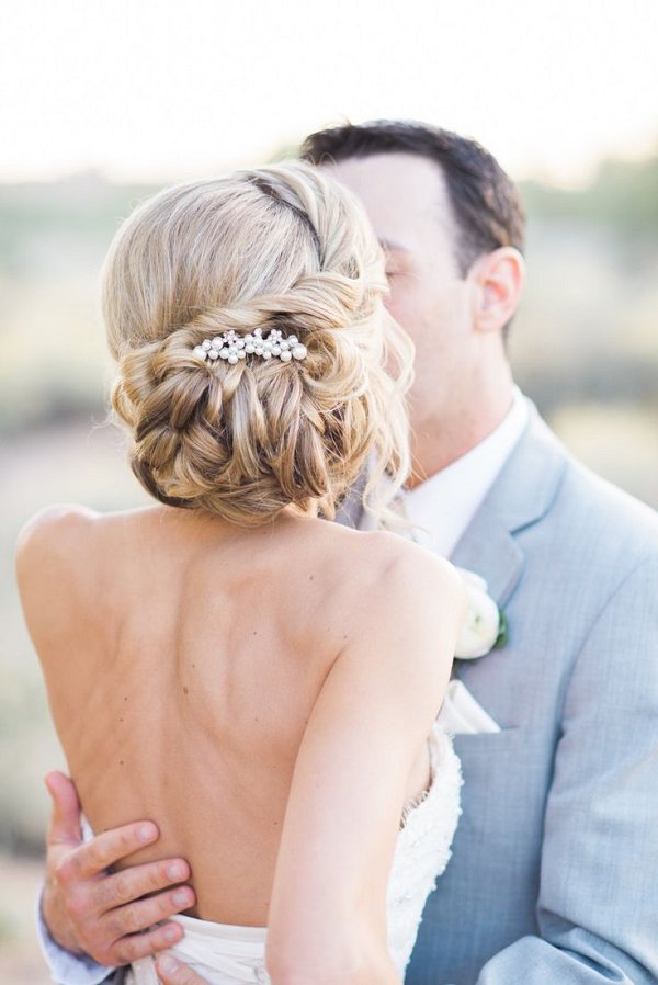 twisted low messy wedding chignon hairstyle and backless wedding gown