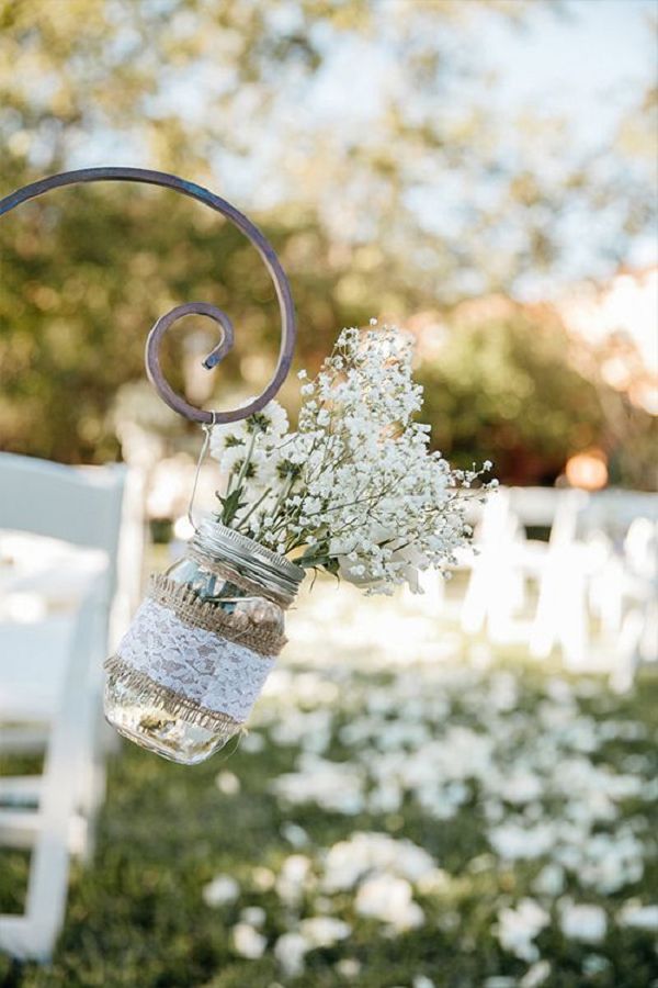 Aisle decor idea with baby’s breath and lace