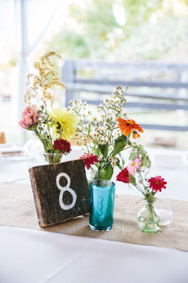 Rustic wedding centerpieces with mismatched bottles