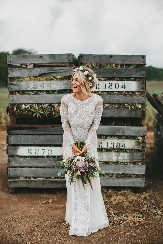 bohemian lace wedding dress and protea wedding bouquet