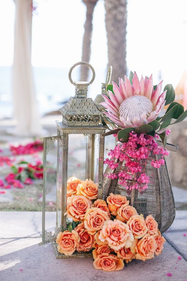 colorful beachy cabo coral roses and pink protea wedding decor