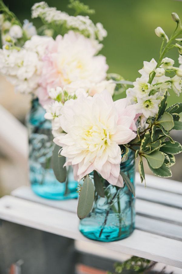 wedding ceremony floral and blue mason jar wedding decor