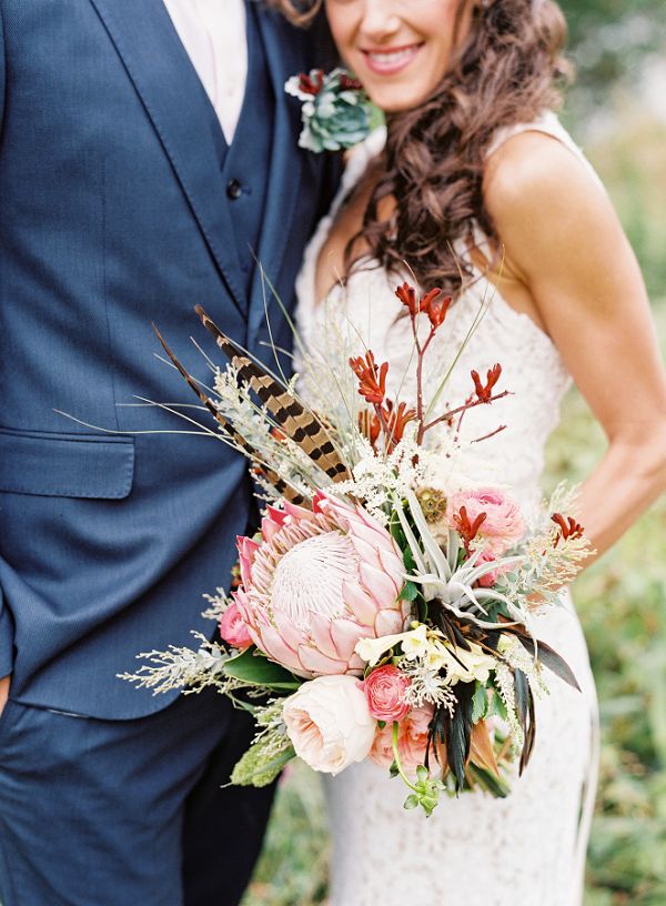 whimsical protea and feather boho wedding bouquet