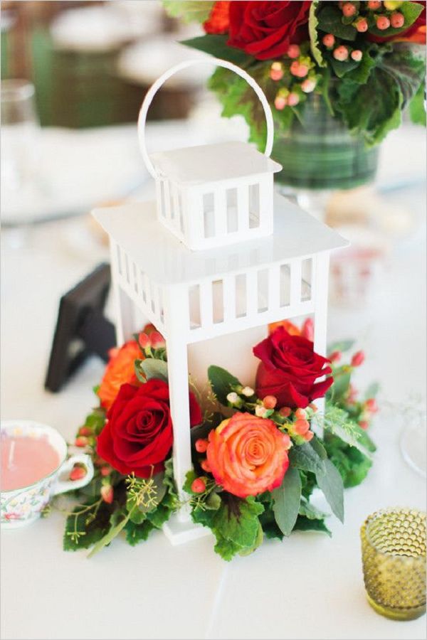 white lantern and red roses wedding centerpiece
