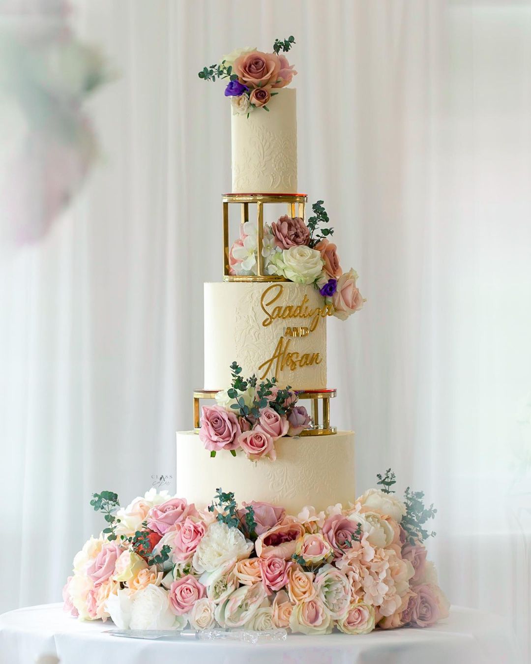 romantic three tier floating wedding cake with flowers via classacakes