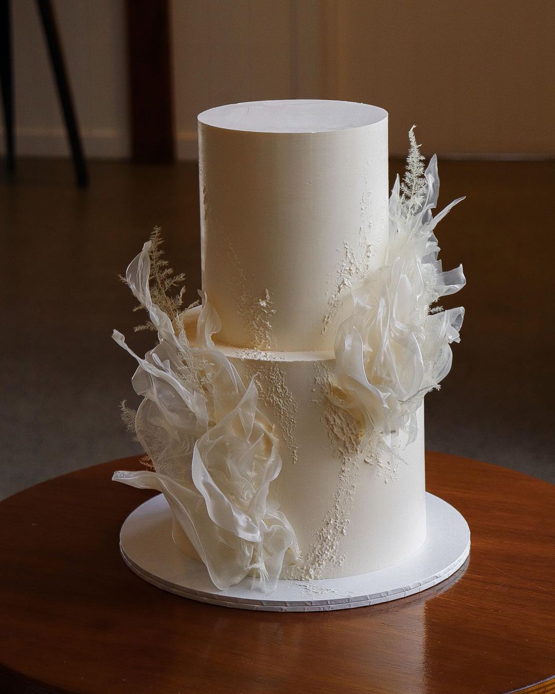 romantic two tier all white wedding cake via milkandhoney.cakecreative