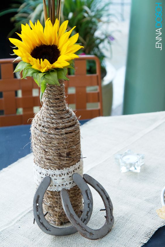 Sunflower, horseshoes, twine & wine bottle rustic country wedding centerpiece